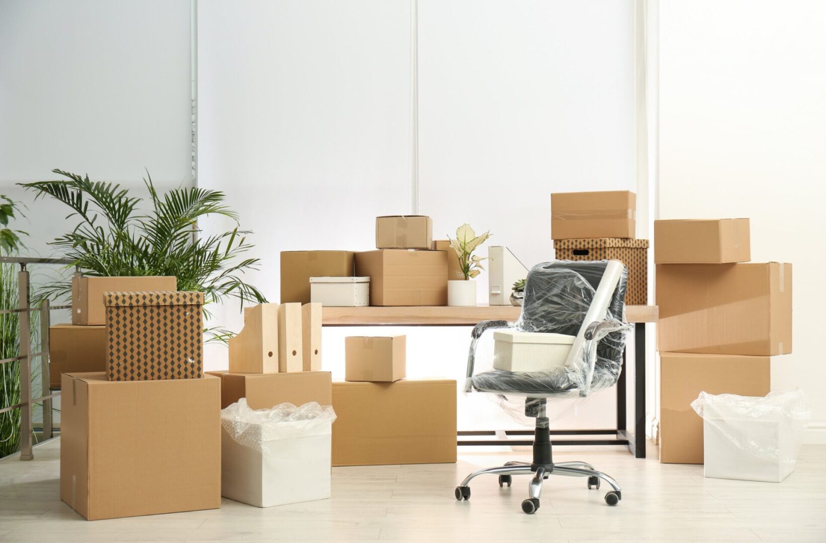 Office space with moving boxes and chair.