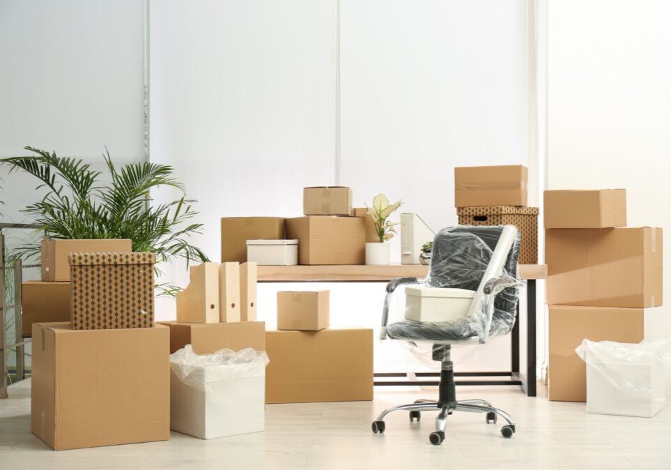 Office space with moving boxes and chair.